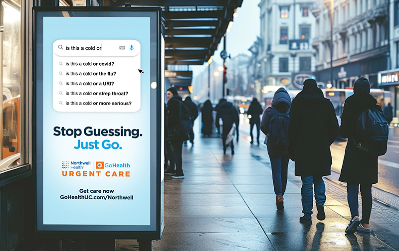 A street scene with people walking past a bus stop advertisement. The ad displays a search bar with health-related questions like 