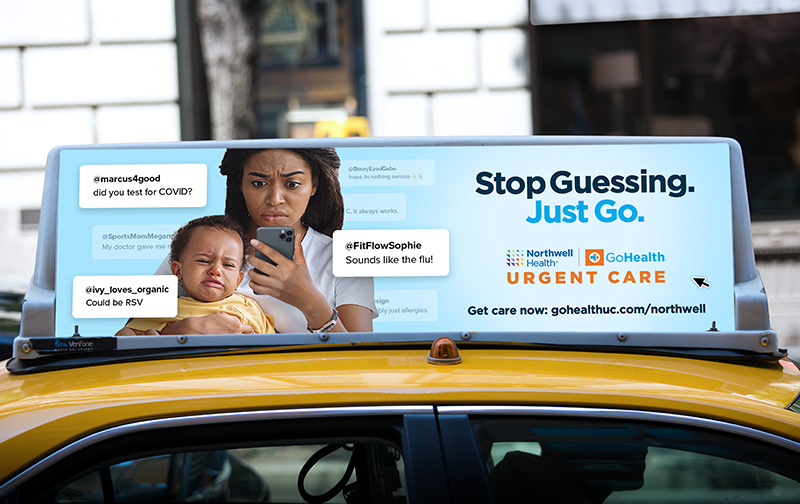 A taxi advertisement shows a concerned woman holding a baby, both looking at a phone. Text on the ad mentions RSV, COVID, and flu. Logos for Northwell Health and GoHealth Urgent Care are visible, with a call to action: 